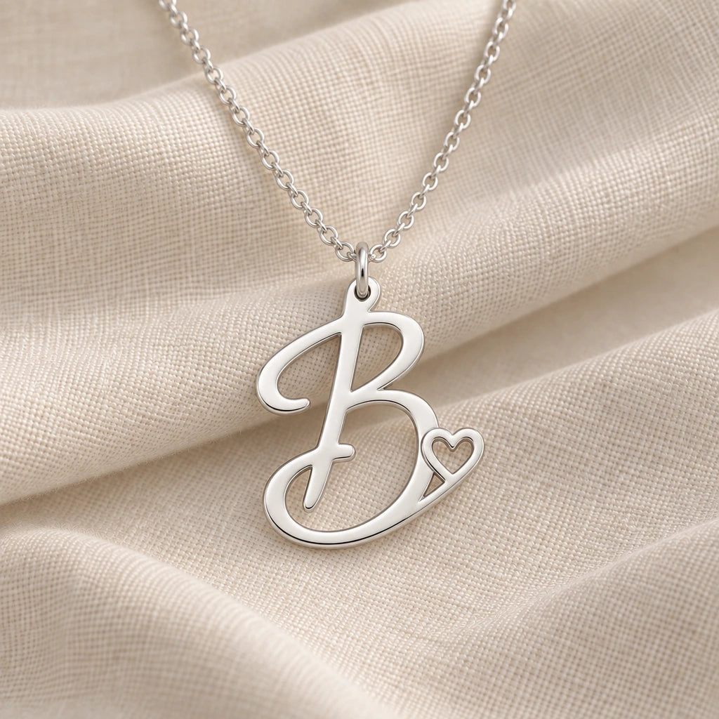 925 sterling silver b initial heart pendant necklace on softly folded cream linen