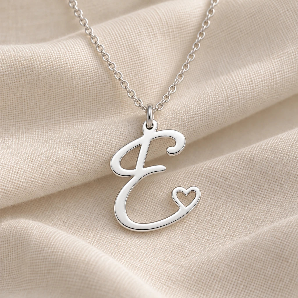 925 sterling silver e initial heart pendant necklace on softly folded cream linen