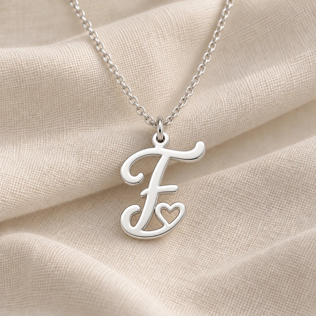 925 sterling silver f initial heart pendant necklace on softly folded cream linen