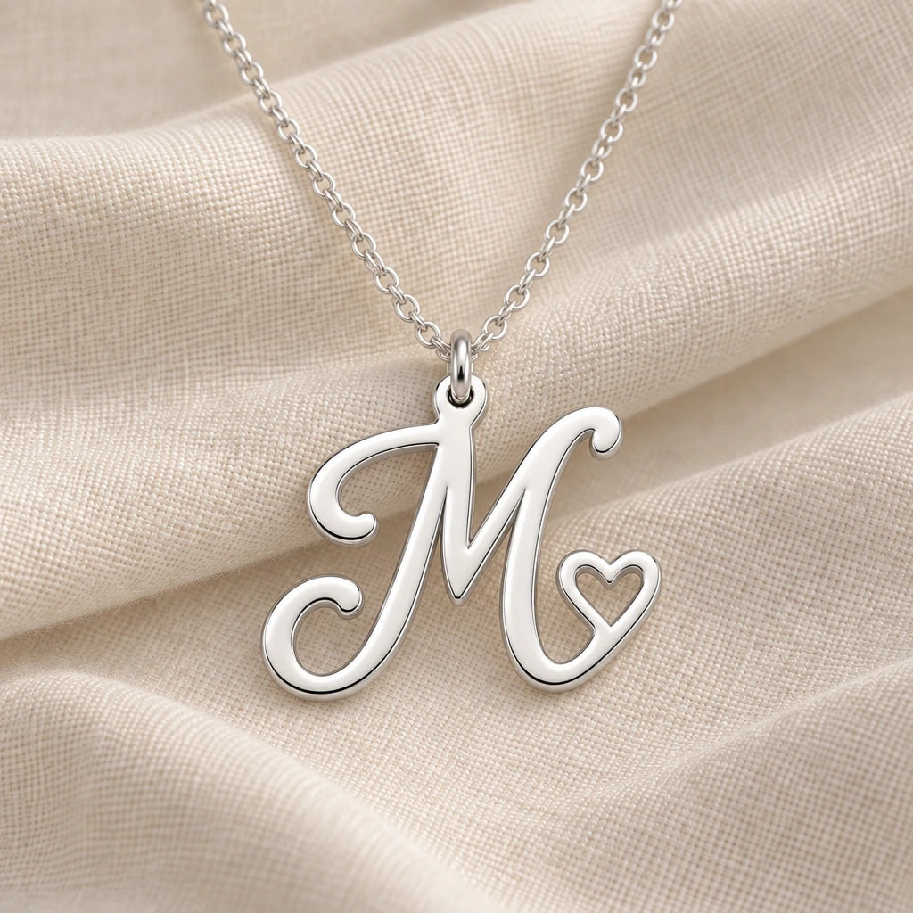 925 sterling silver m initial heart pendant necklace on softly folded cream linen