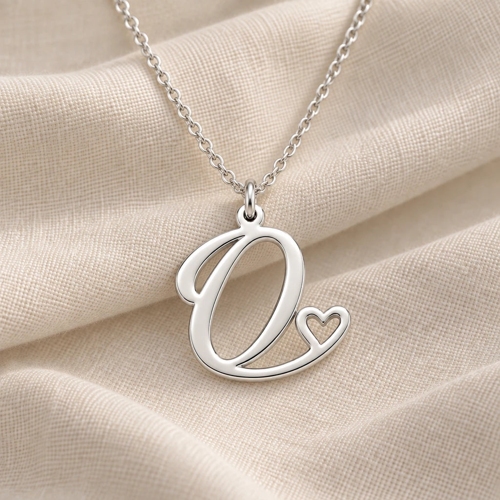 925 sterling silver o initial heart pendant necklace on softly folded cream linen