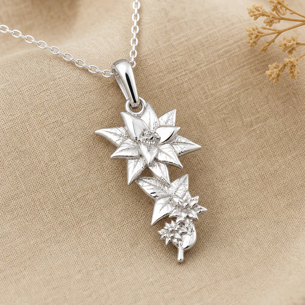 Close-up of silver lily pendant with star shaped bloom and cascading leaves