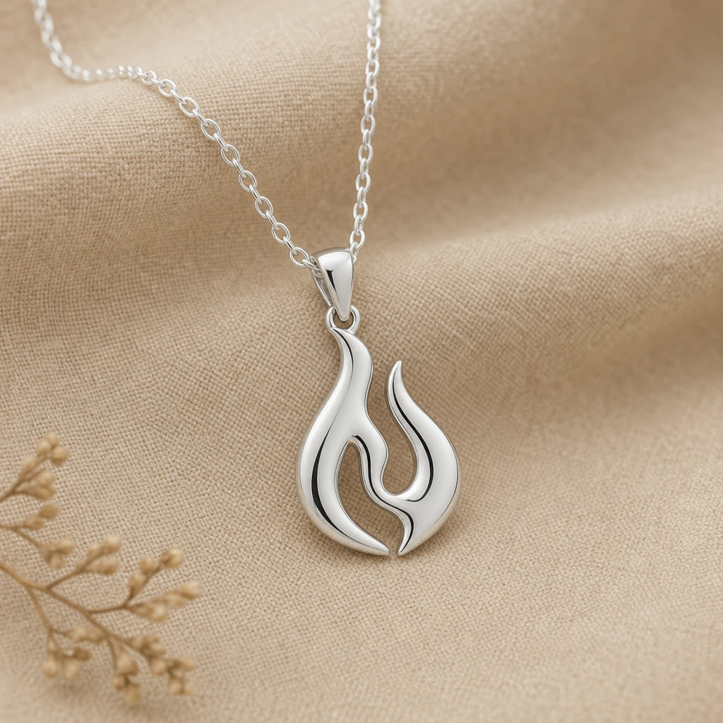 Close-up of silver flame pendant with two polished flame tongues