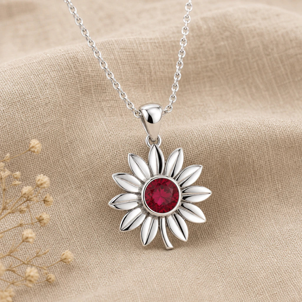 Close-up of silver sunflower pendant with round stone centre