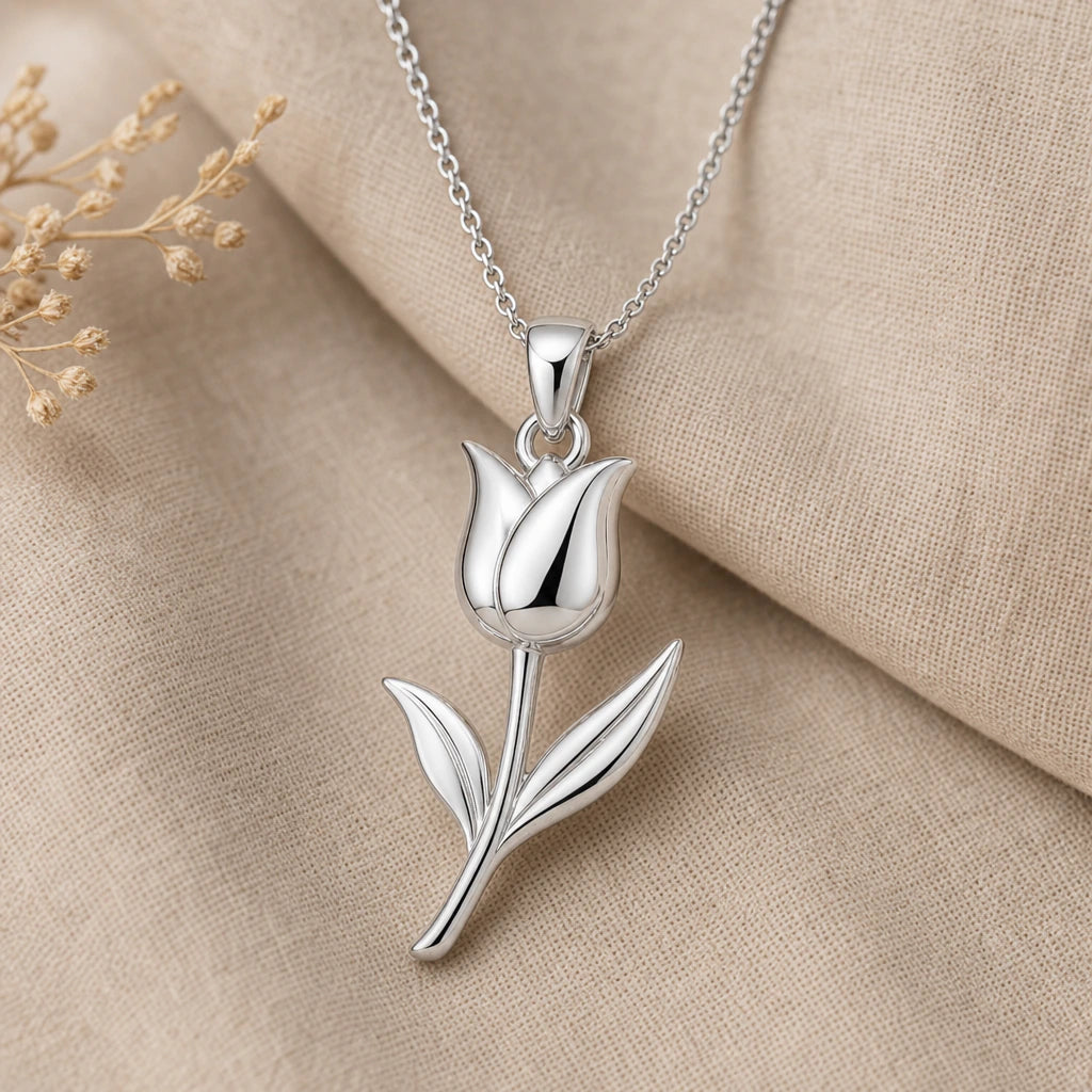 Close-up of silver tulip pendant with polished petals and two leaves