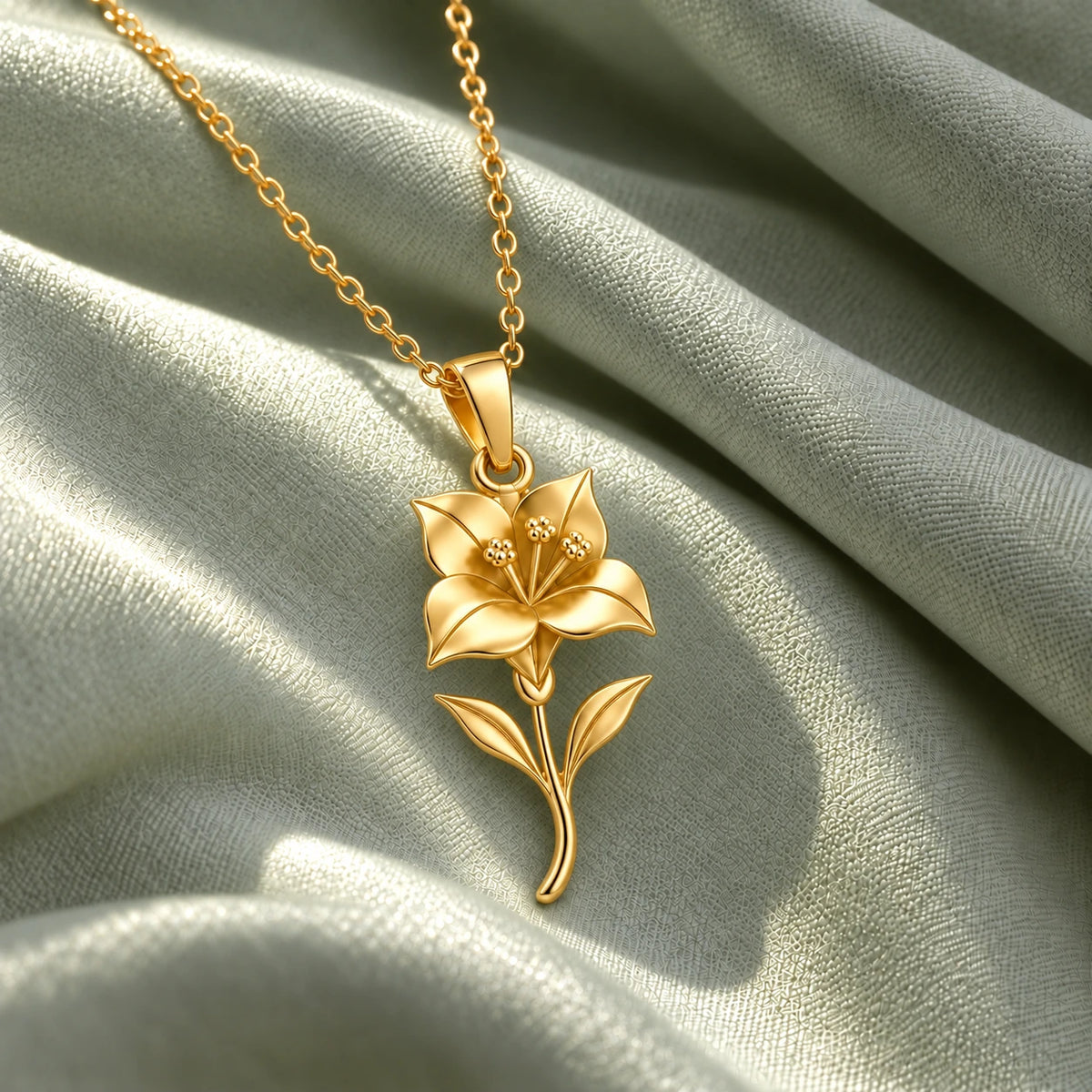 18k gold plated bougainvillea necklace on sage fabric