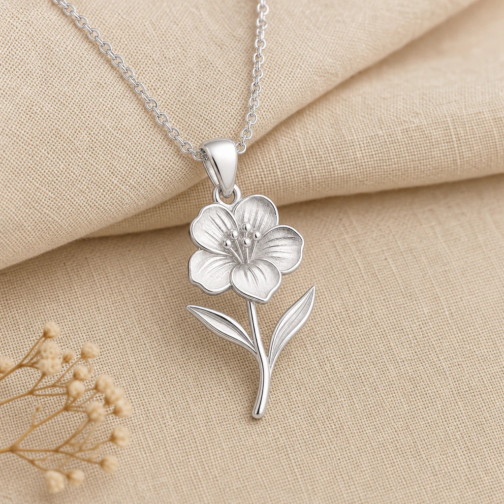 Close-up of silver wallflower pendant with ribbed petals and raised stamens