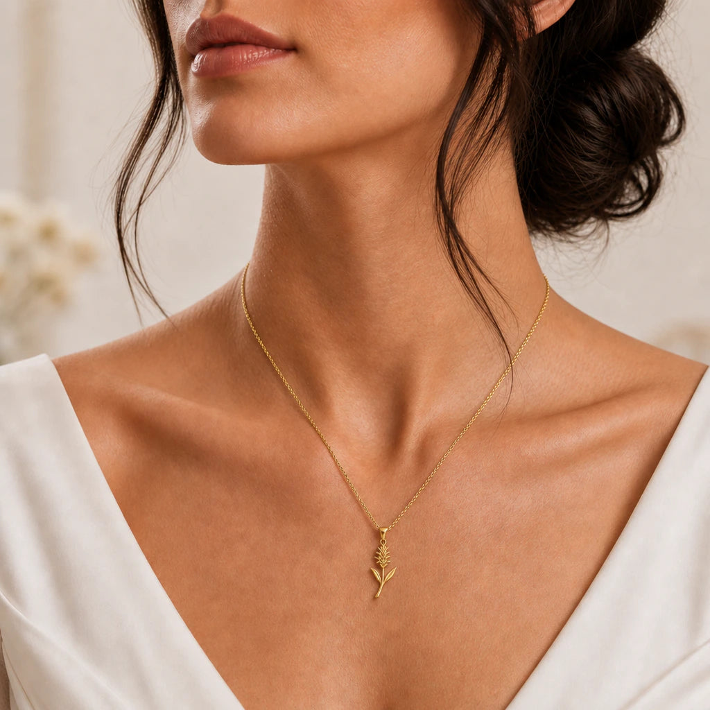 Gold bromeliad flower necklace styled with a cream dress