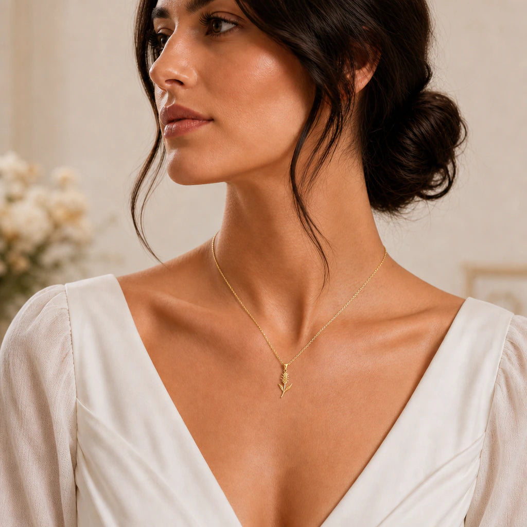 Gold bromeliad flower pendant necklace worn by model