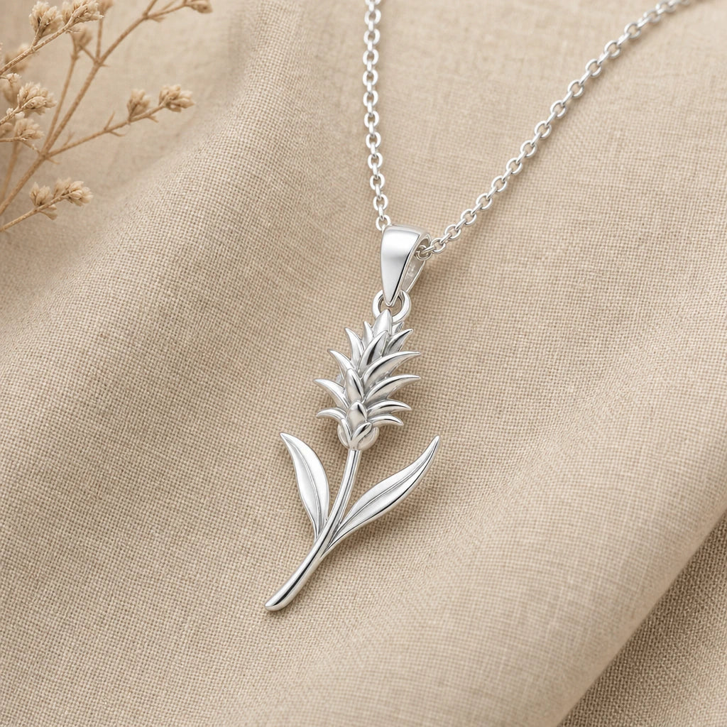 Bromeliad flower necklace in polished 925 sterling silver on cream fabric
