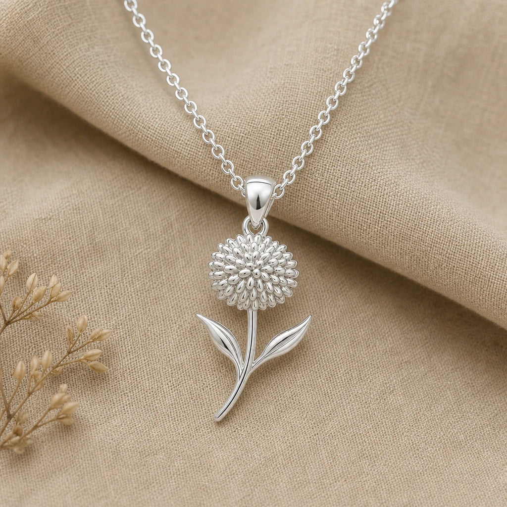 Close-up of polished silver allium flower necklace with detailed floral head and leaves