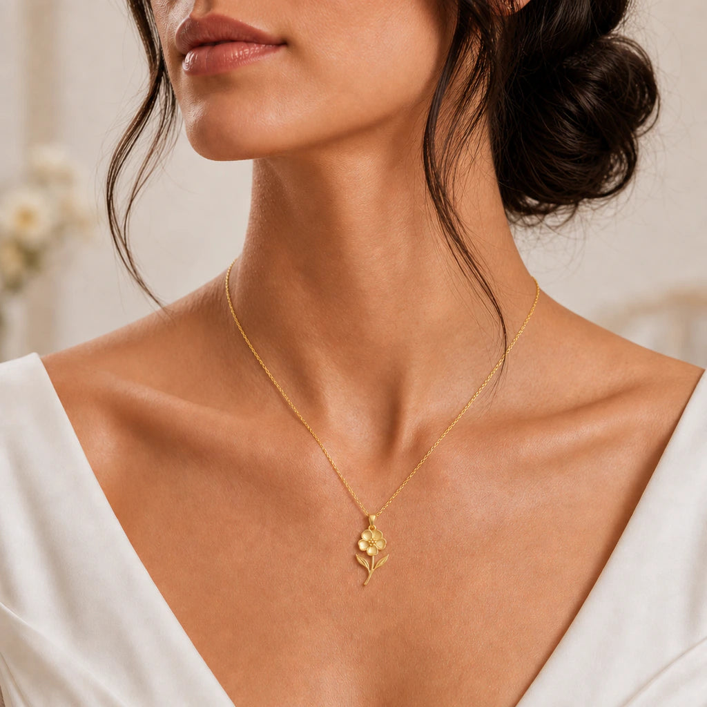 Sterling silver Waxflower Pendant Necklace with five-petal flower and leaf details on neutral linen