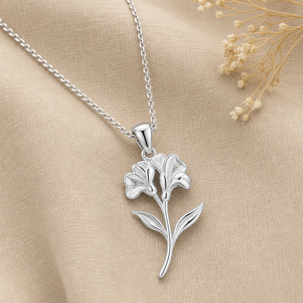 Close-up of silver sweet pea pendant with two ruffled blooms and leaves
