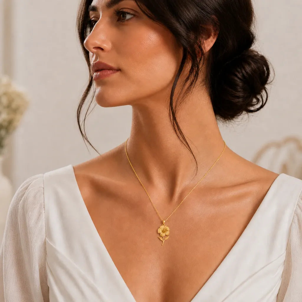 Hibiscus flower pendant necklace worn with white clothing, natural lifestyle photograph