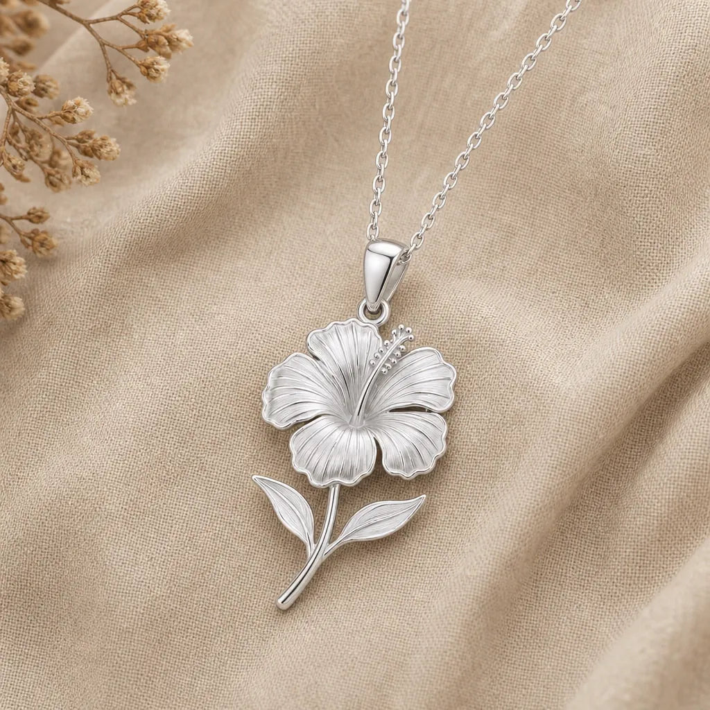925 sterling silver hibiscus flower pendant necklace on softly folded cream linen