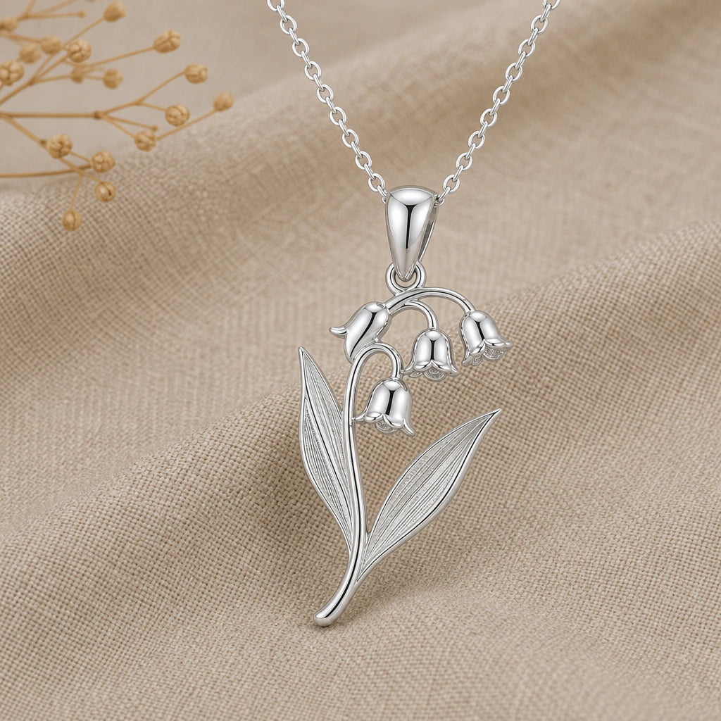 Close-up of silver lily of the valley pendant with bell flowers and ribbed leaves