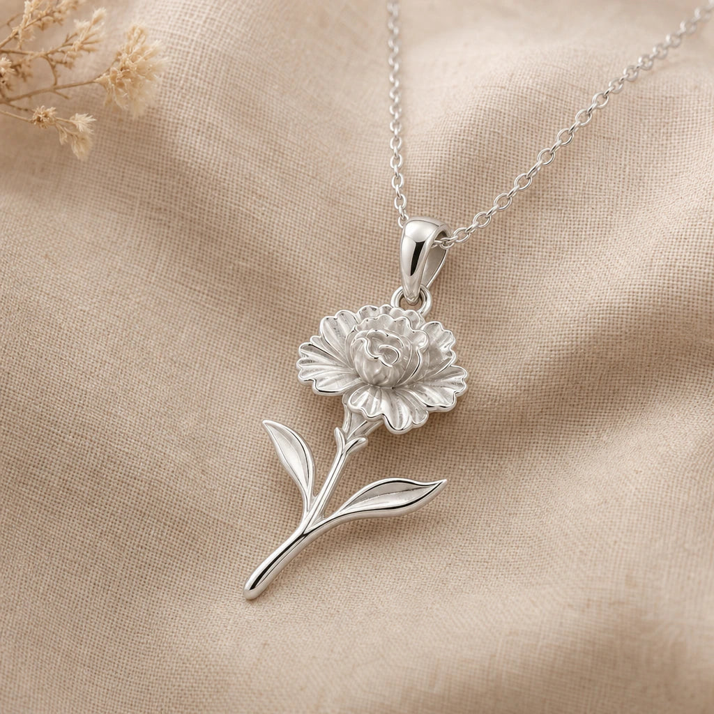 Close-up of silver carnation pendant with frilled petals and two leaves