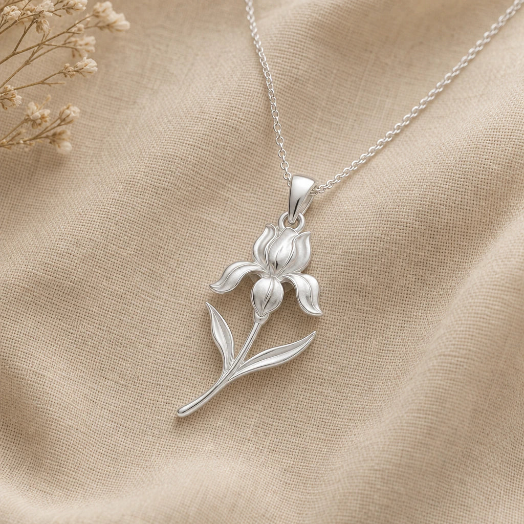 Close-up of silver iris pendant with upright petals and curling falls