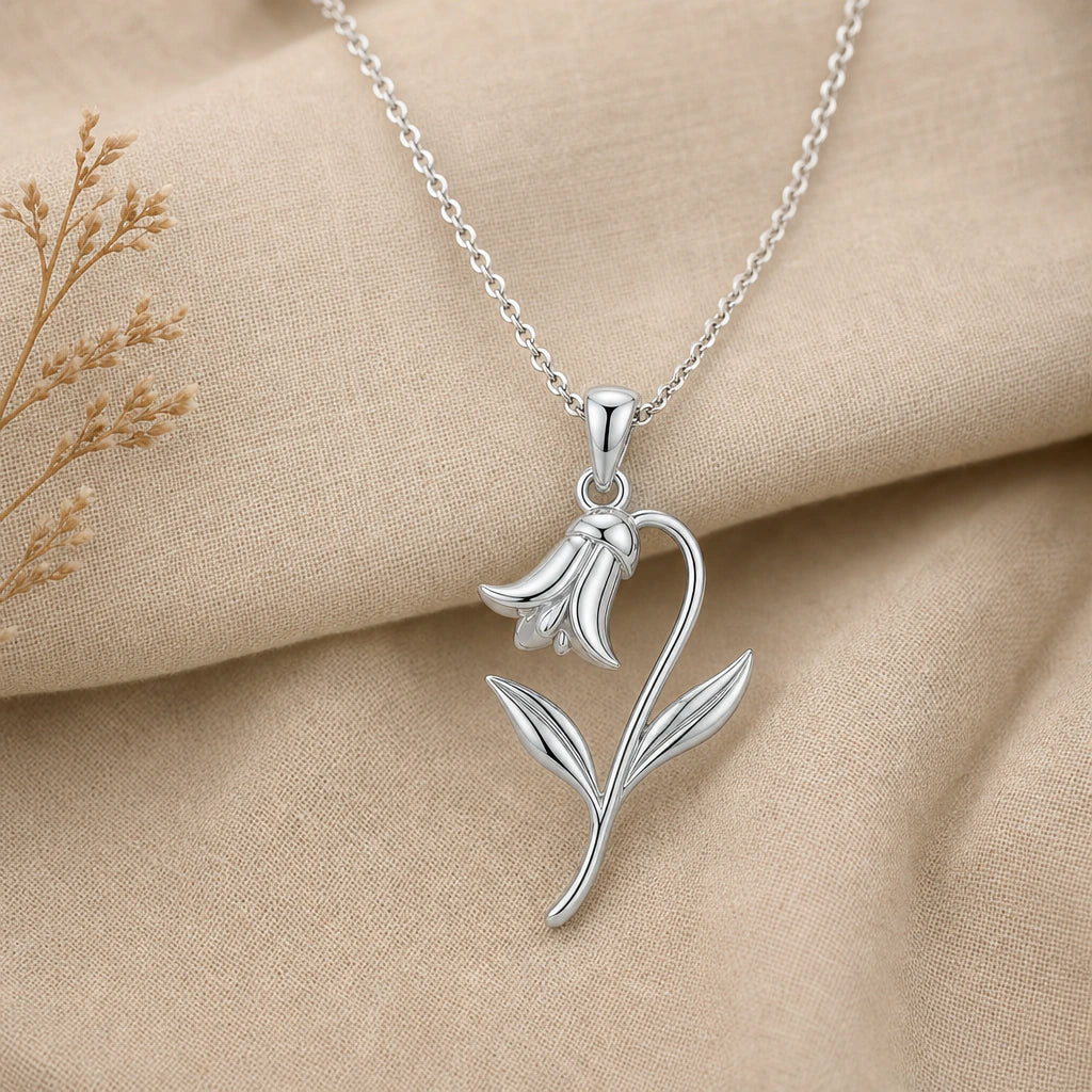 Close-up of silver bluebell pendant with nodding bell flower and curved leaves