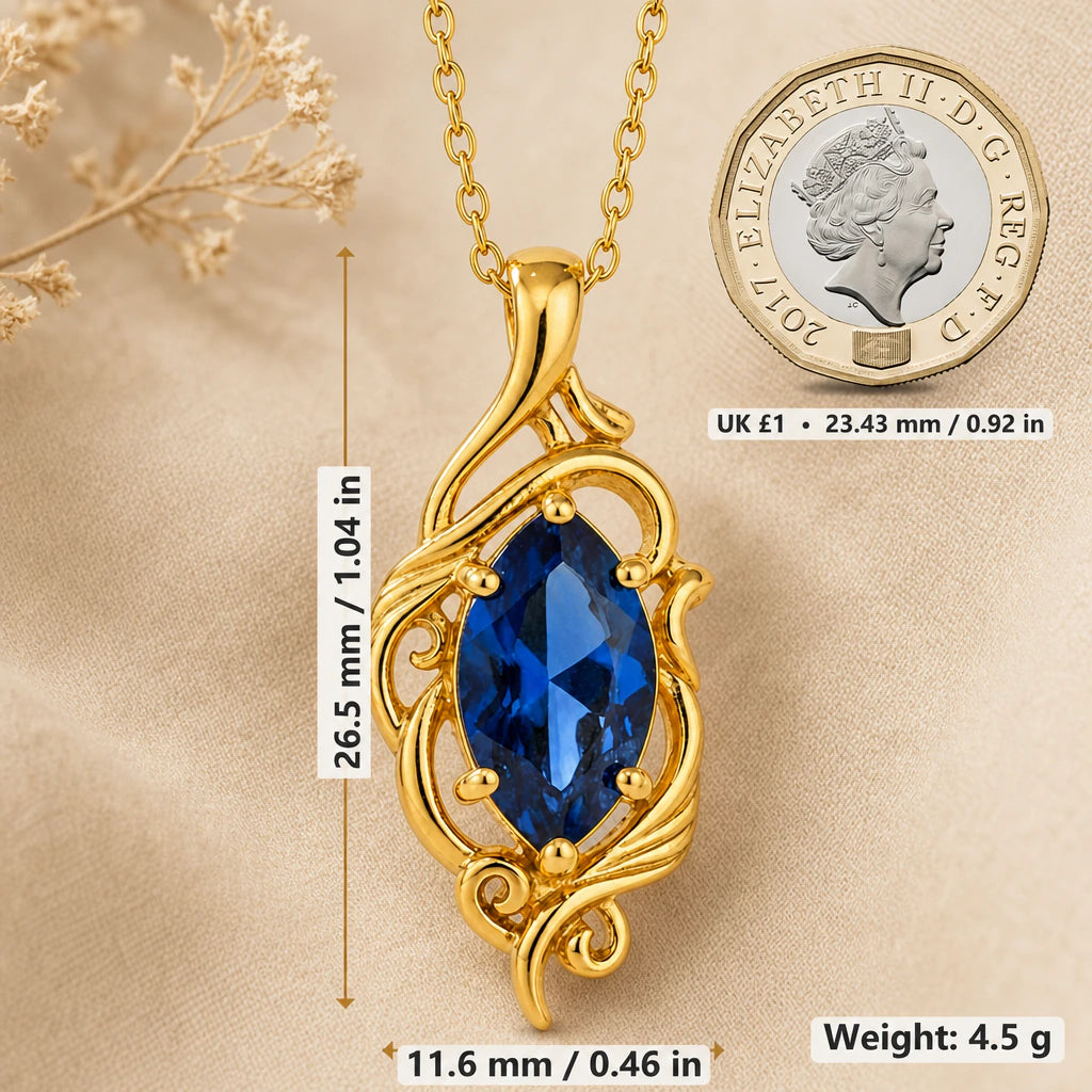 Elven vine necklace size image showing 26.5 mm height, 11.6 mm width and 4.5 g weight beside a UK pound coin