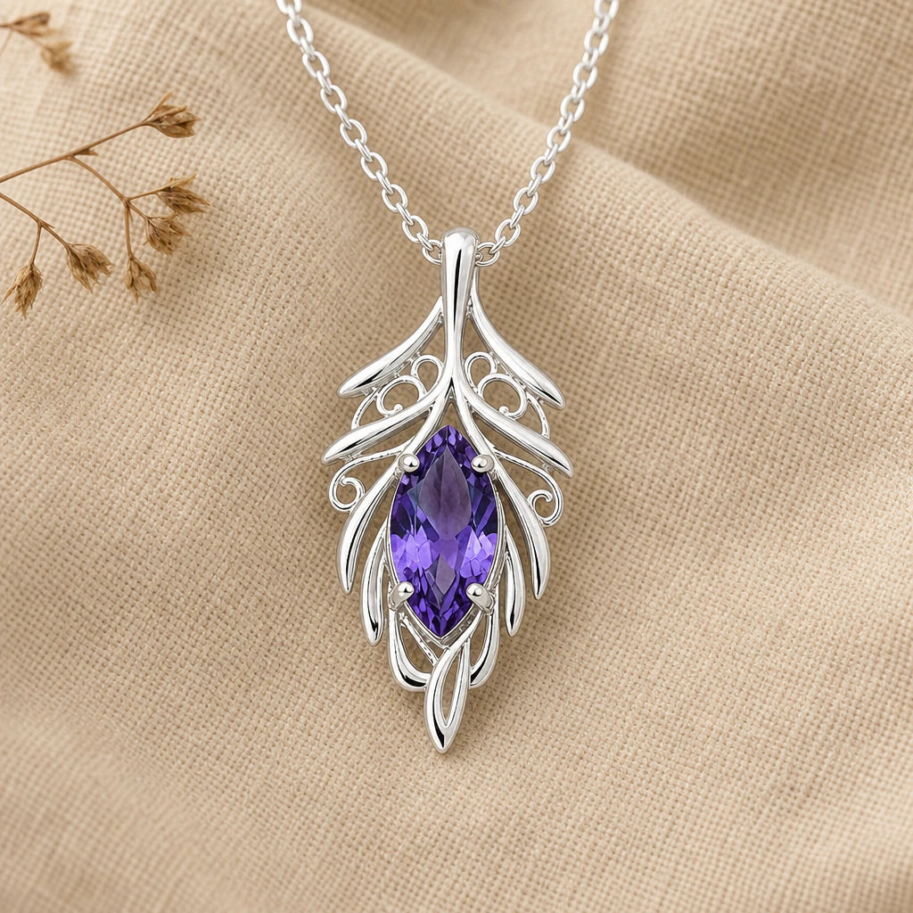 Close-up of silver elven leaf pendant with openwork veins and marquise stone