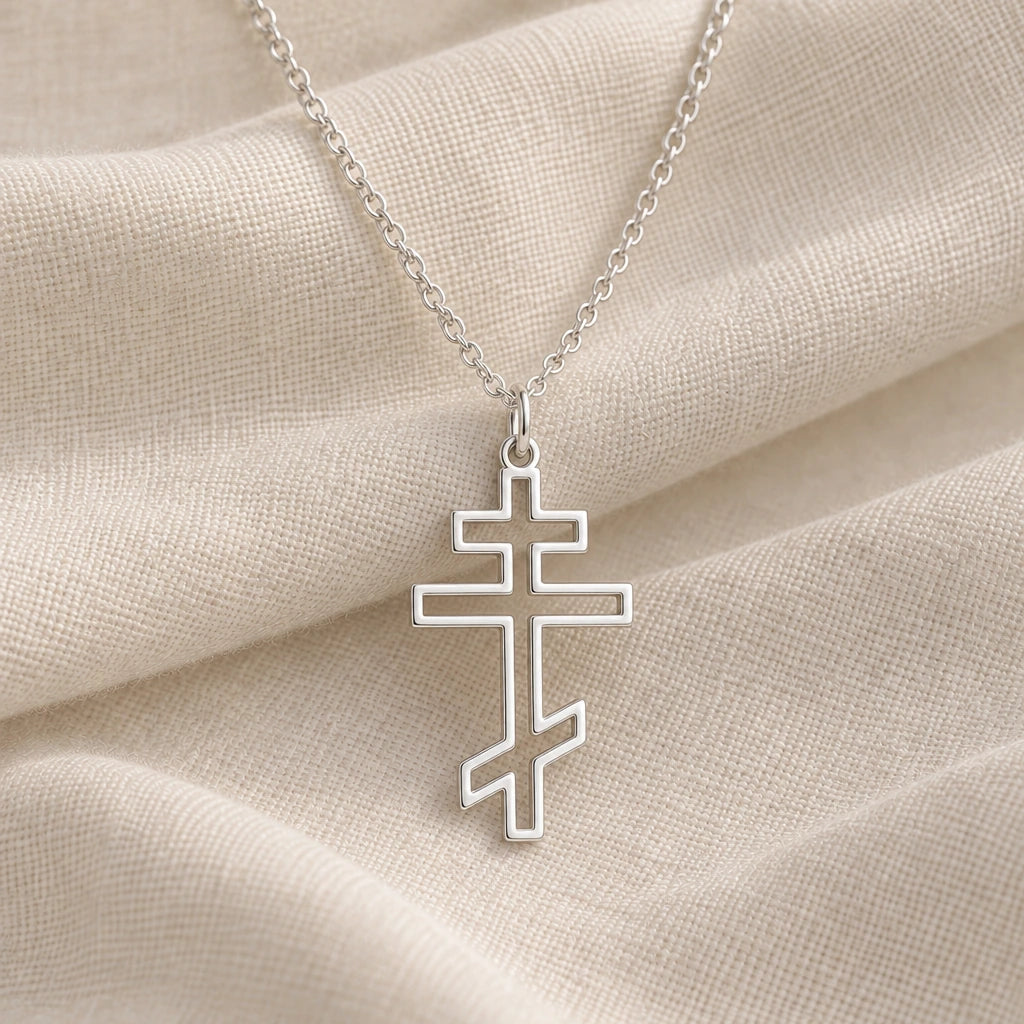 925 sterling silver orthodox cross outline pendant necklace on cream fabric