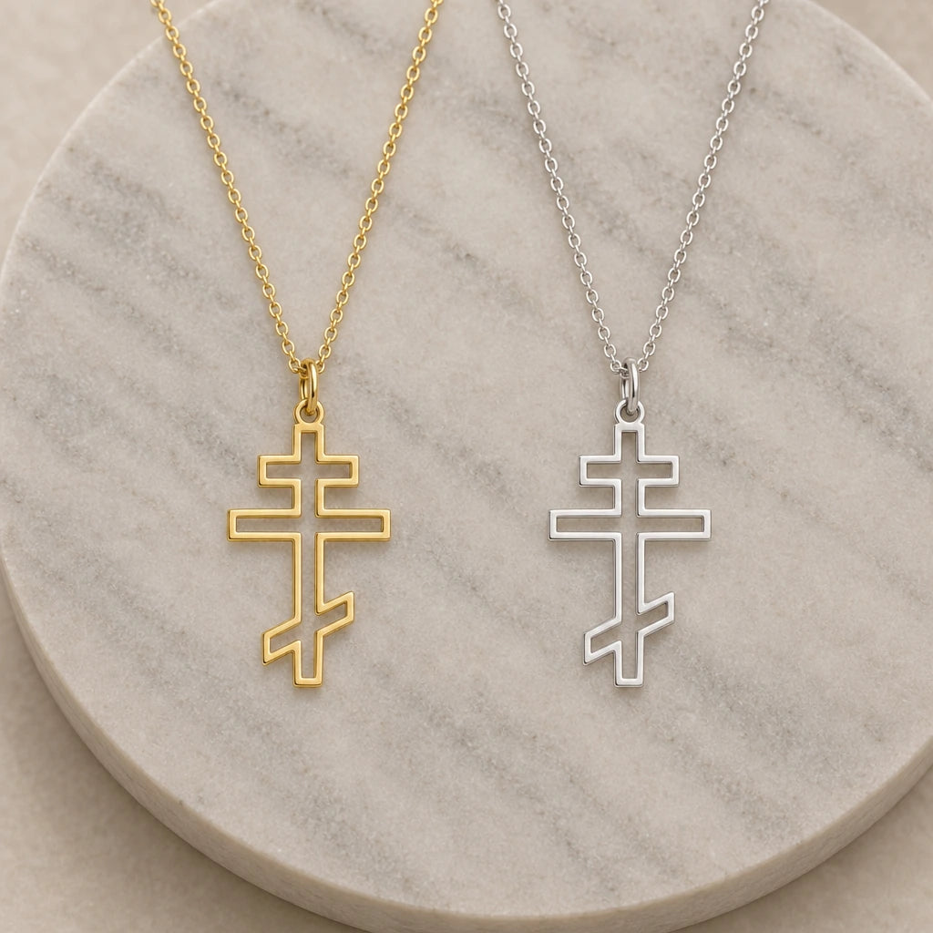 Orthodox Cross Outline pendant necklace in silver and gold finishes side by side
