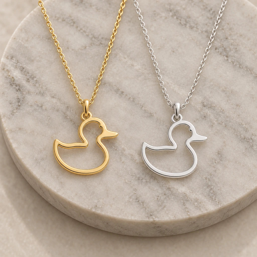 Rubber Duck Outline pendant necklace in silver and gold finishes side by side