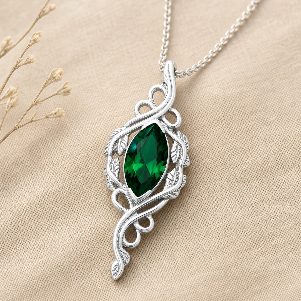 Close-up of silver marquise vine pendant with stone and veined leaves
