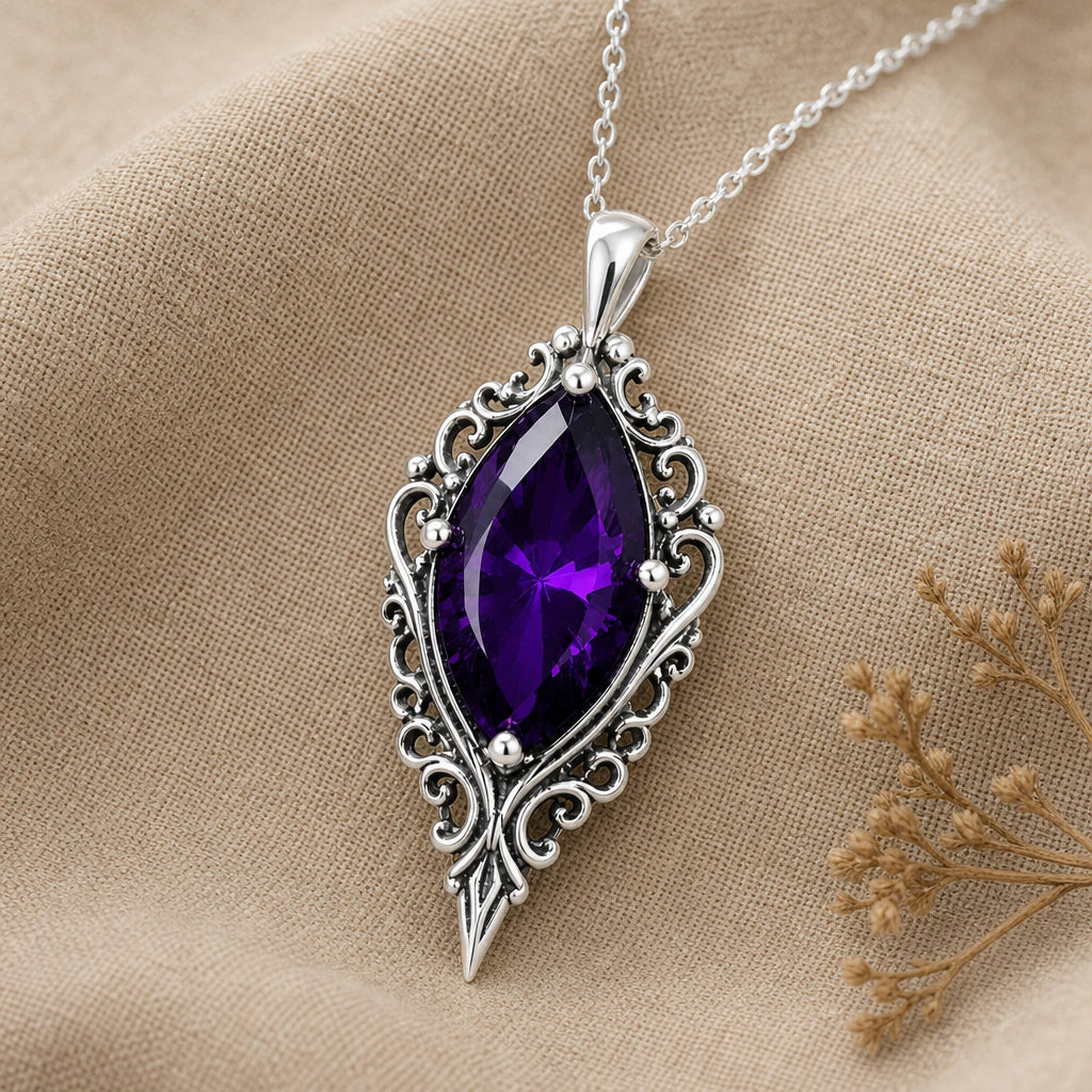 Close-up of silver gothic baroque pendant with marquise stone and scrollwork