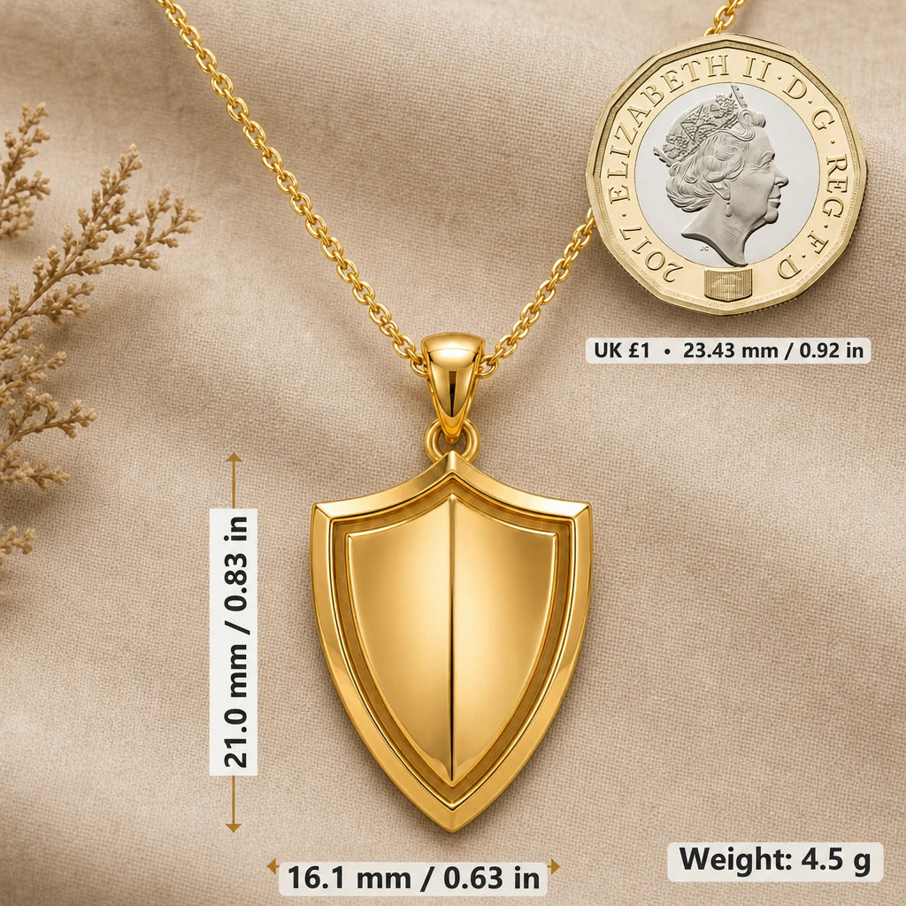Guardian shield necklace size image showing 21 mm height, 16.1 mm width and 4.5 g weight beside a UK pound coin