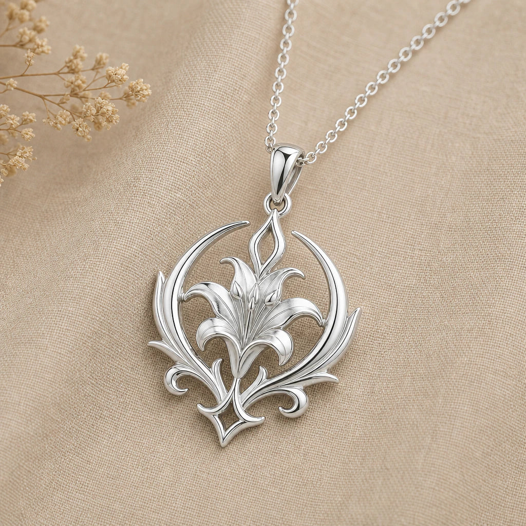 Close-up of silver lily pendant framed by a crescent and scrollwork