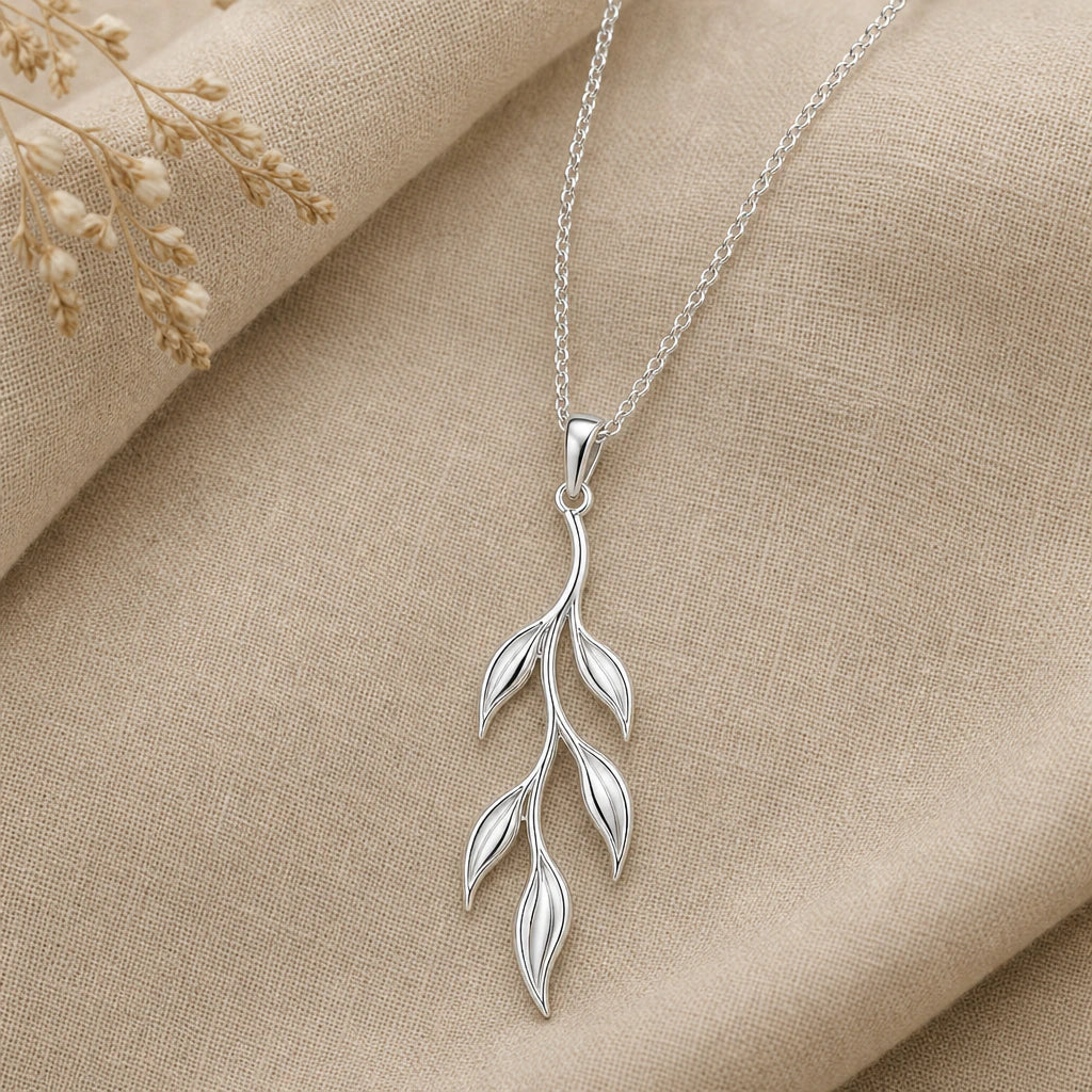 Close-up of silver willow branch pendant with six slender leaves