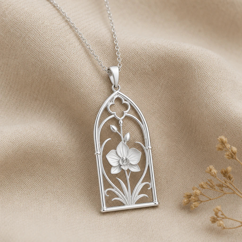 Close-up of silver orchid pendant framed in an arched window