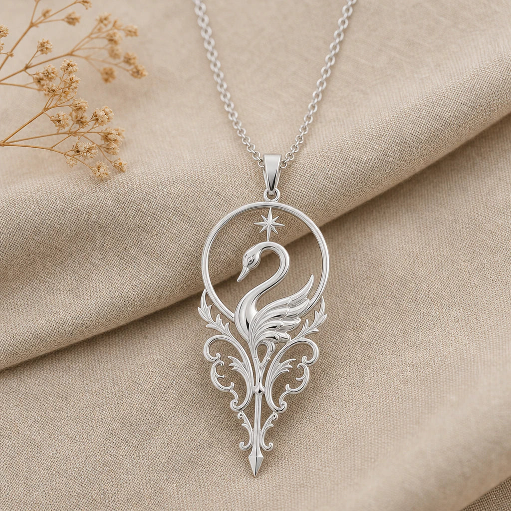 Close-up of silver swan pendant inside a halo with star and scrollwork