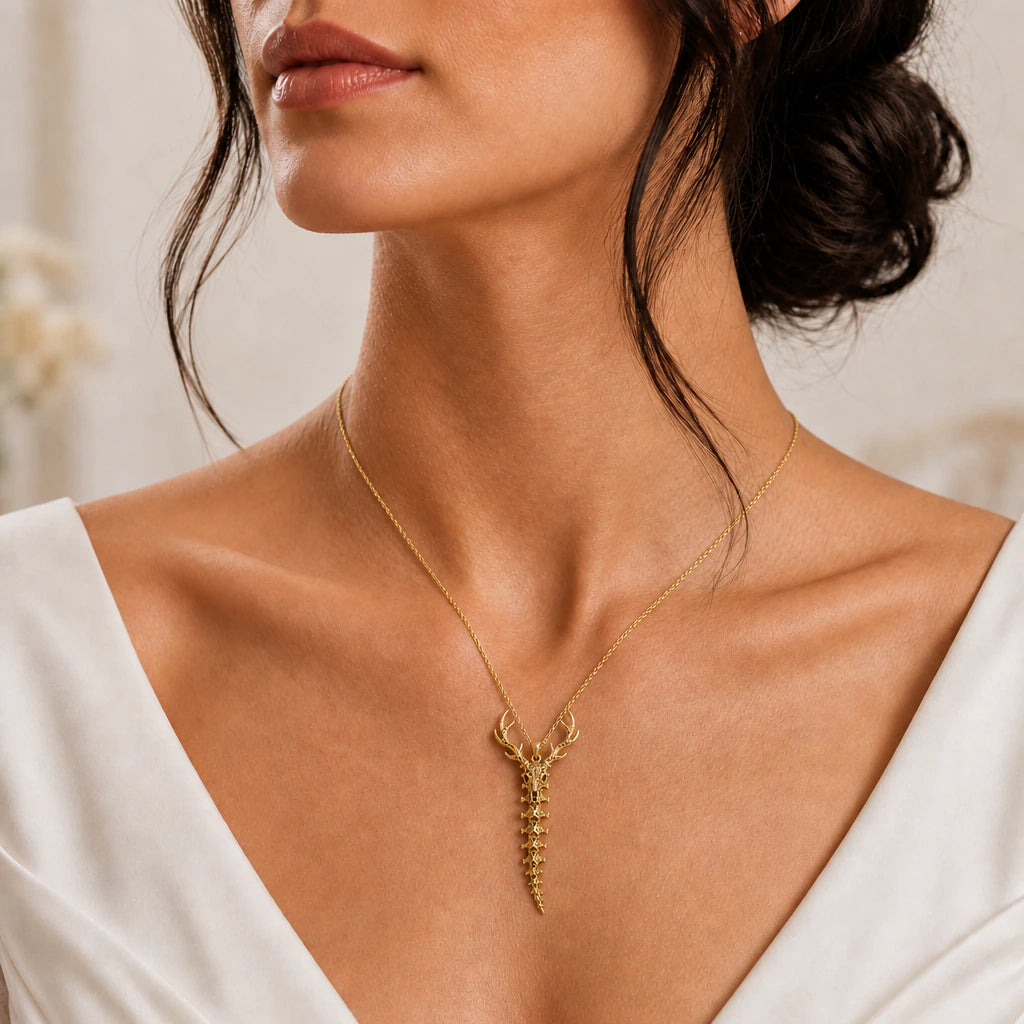 Deer skull and spine pendant necklace worn, close-up