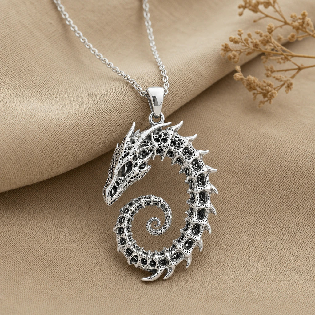 Close-up of silver coiled dragon skeleton pendant with horned skull
