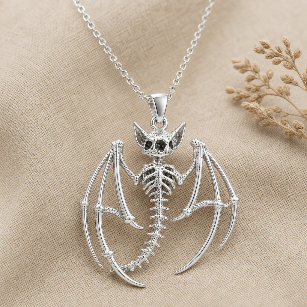 Close-up of silver bat skeleton pendant with wing bones and ribcage
