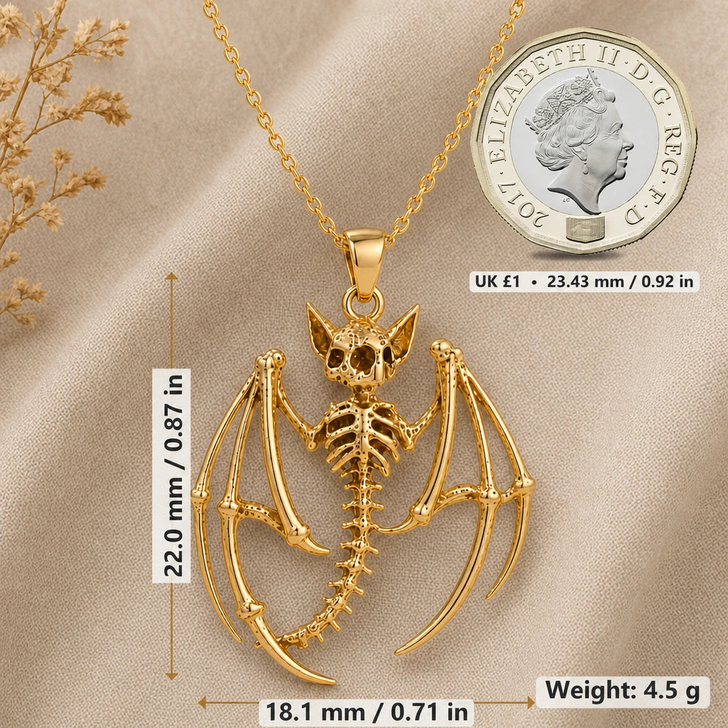 Bat skeleton necklace size image showing 22 mm height, 18.1 mm width and 4.5 g weight beside a UK pound coin