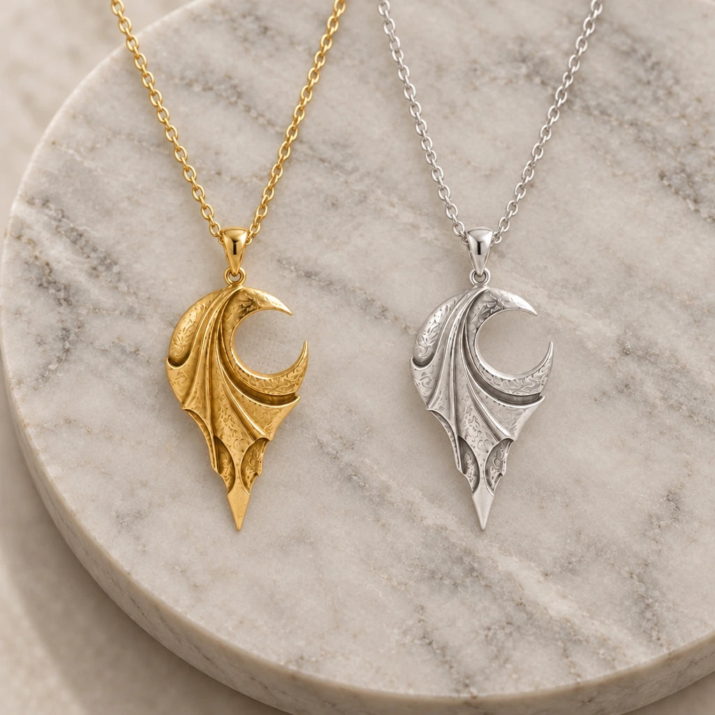 Veiled Eclipse Wing pendant necklace in silver and gold finishes side by side