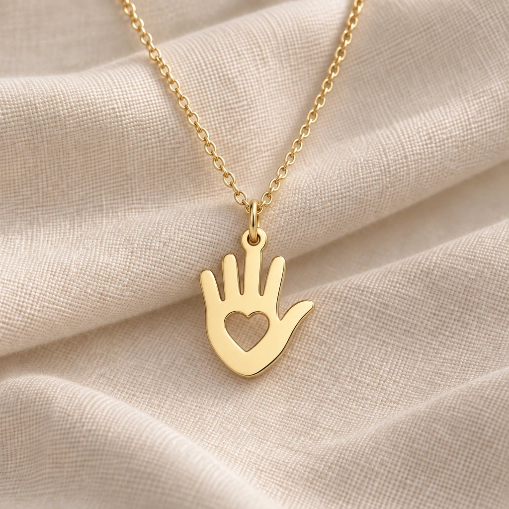 Helping Hand Heart pendant necklace in an 18k gold plated finish