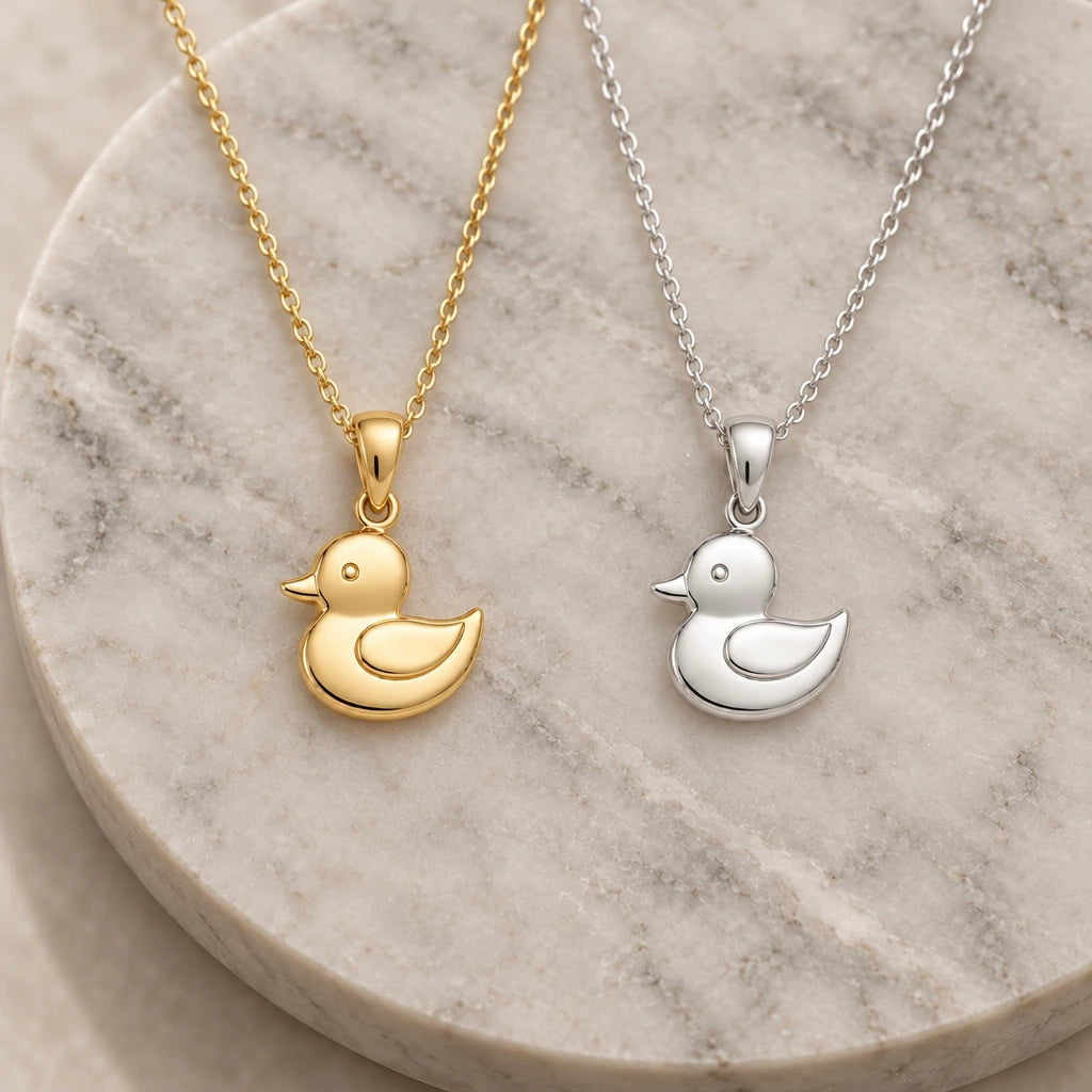 Rubber Duck pendant necklace in silver and gold finishes side by side