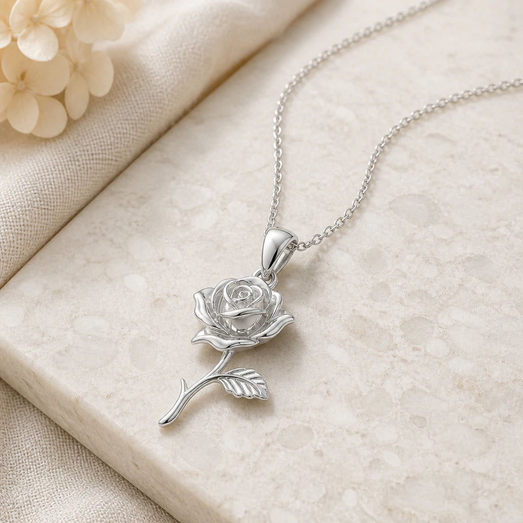 Close-up of silver rose flower pendant showing the sculpted detail