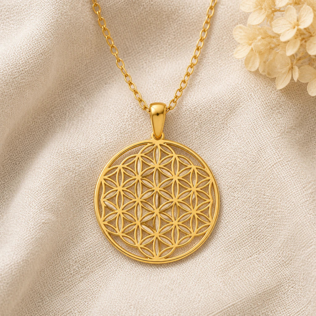 Flower of Life pendant necklace in a warm gold finish on cream fabric