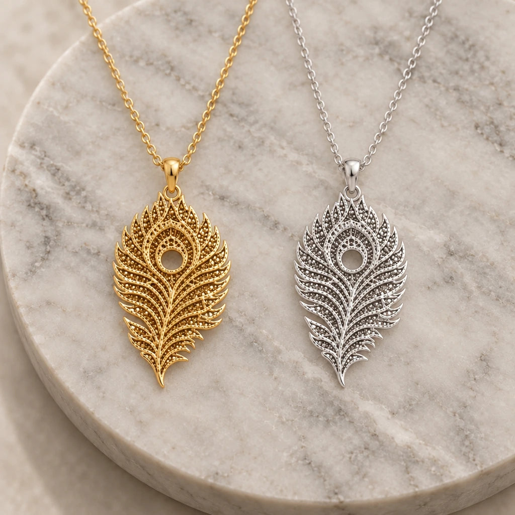 Lunar Peacock Feather pendant necklace in silver and gold finishes side by side