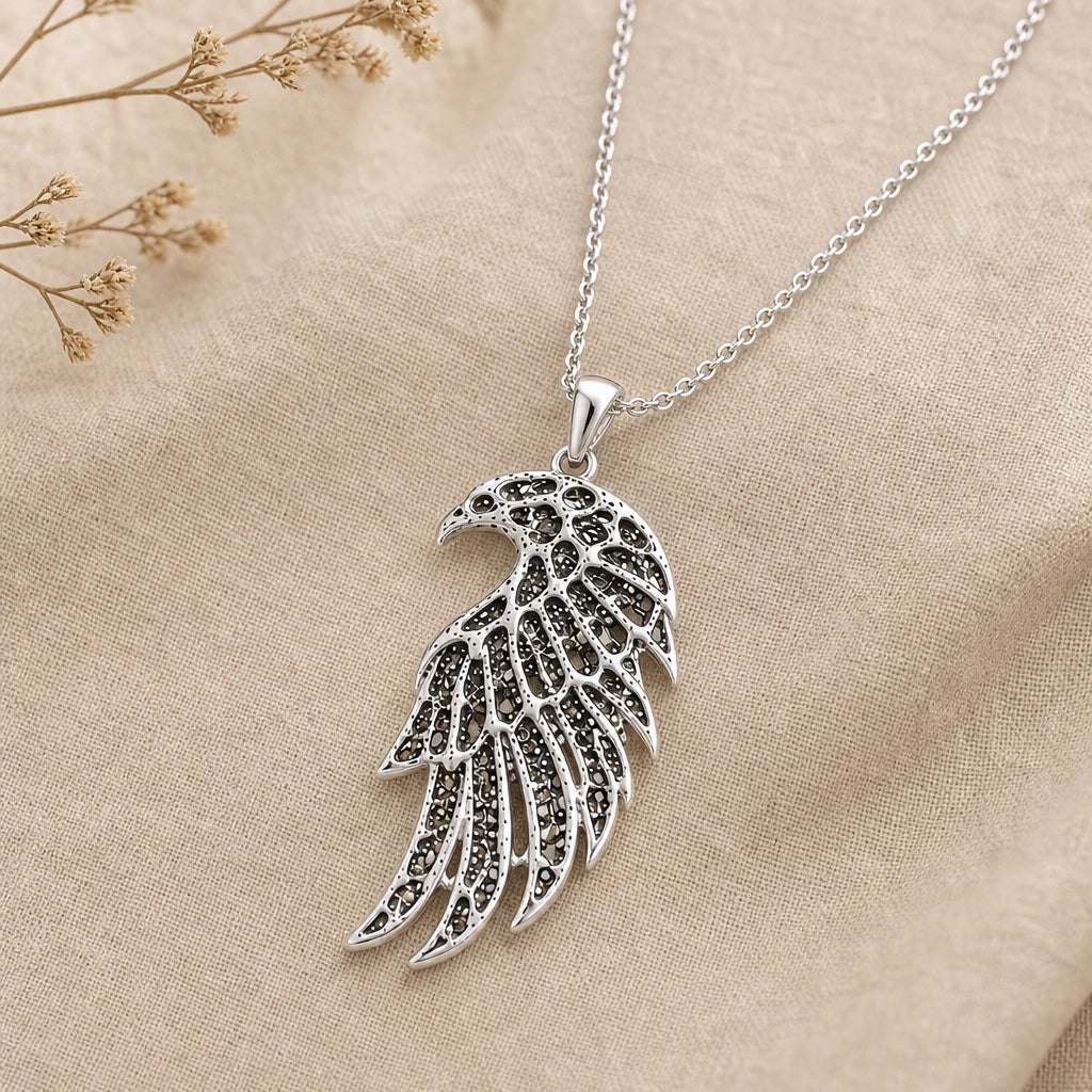 Close-up of silver falcon pendant with openwork lattice wing