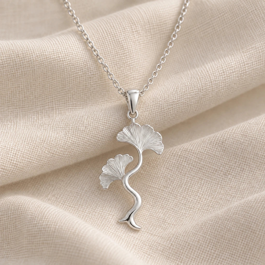925 sterling silver ginkgo wave stem pendant necklace on cream fabric