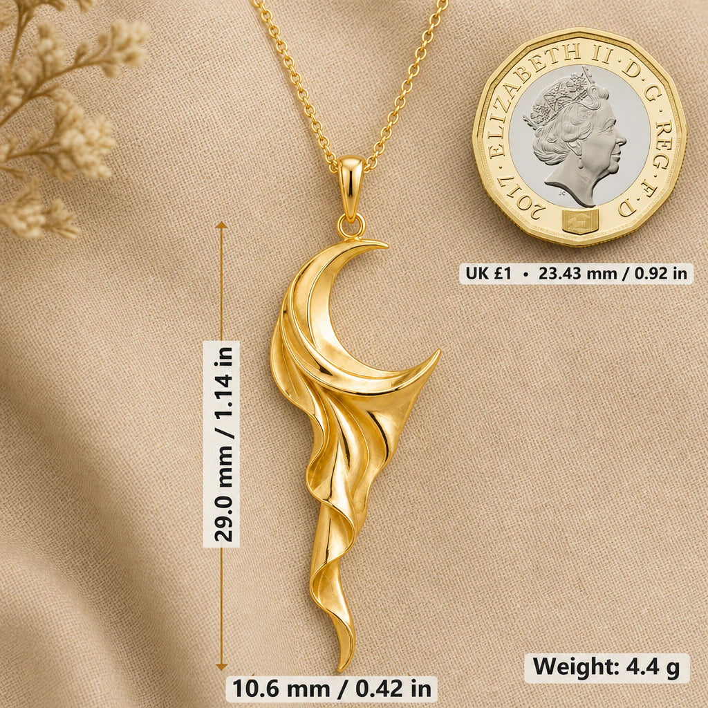 Crescent moon necklace size image showing 29 mm height, 10.6 mm width and 4.4 g weight beside a UK pound coin