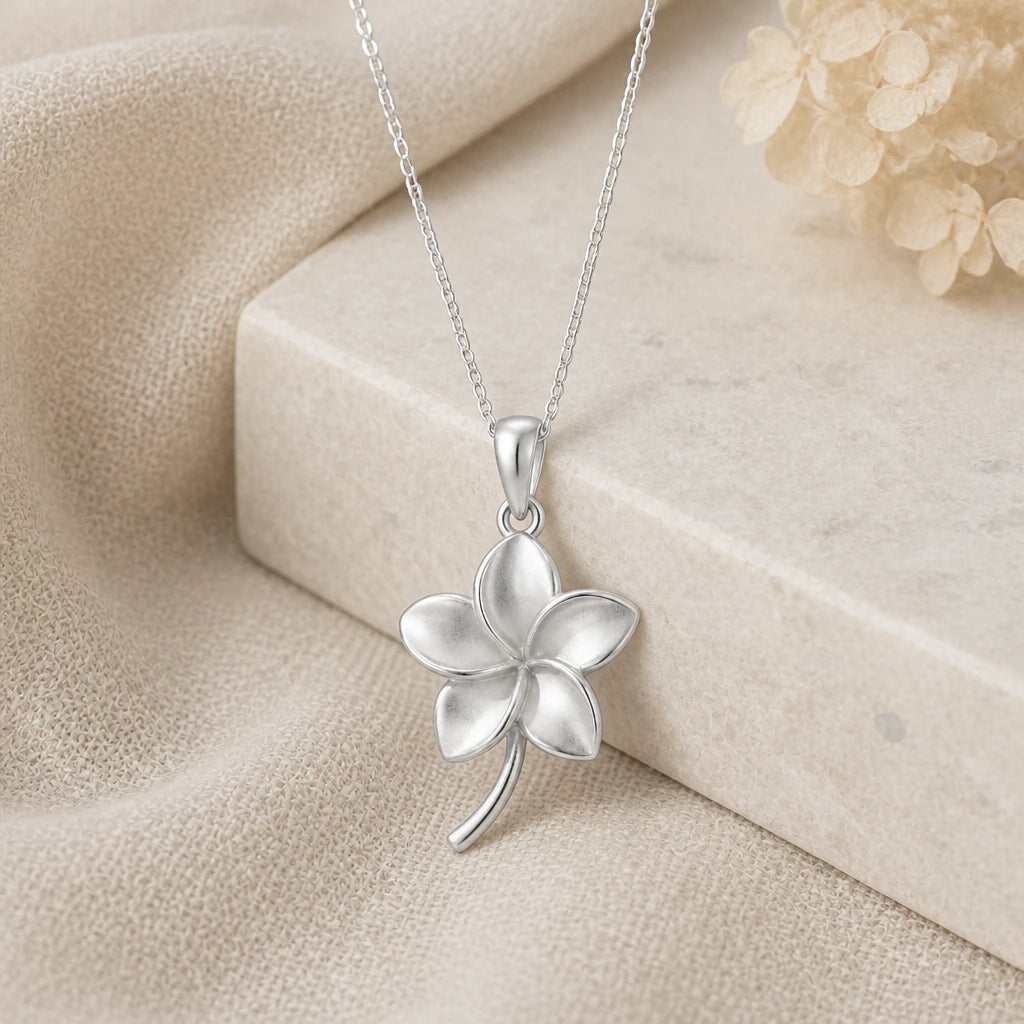 925 sterling silver plumeria flower pendant necklace on softly folded cream linen