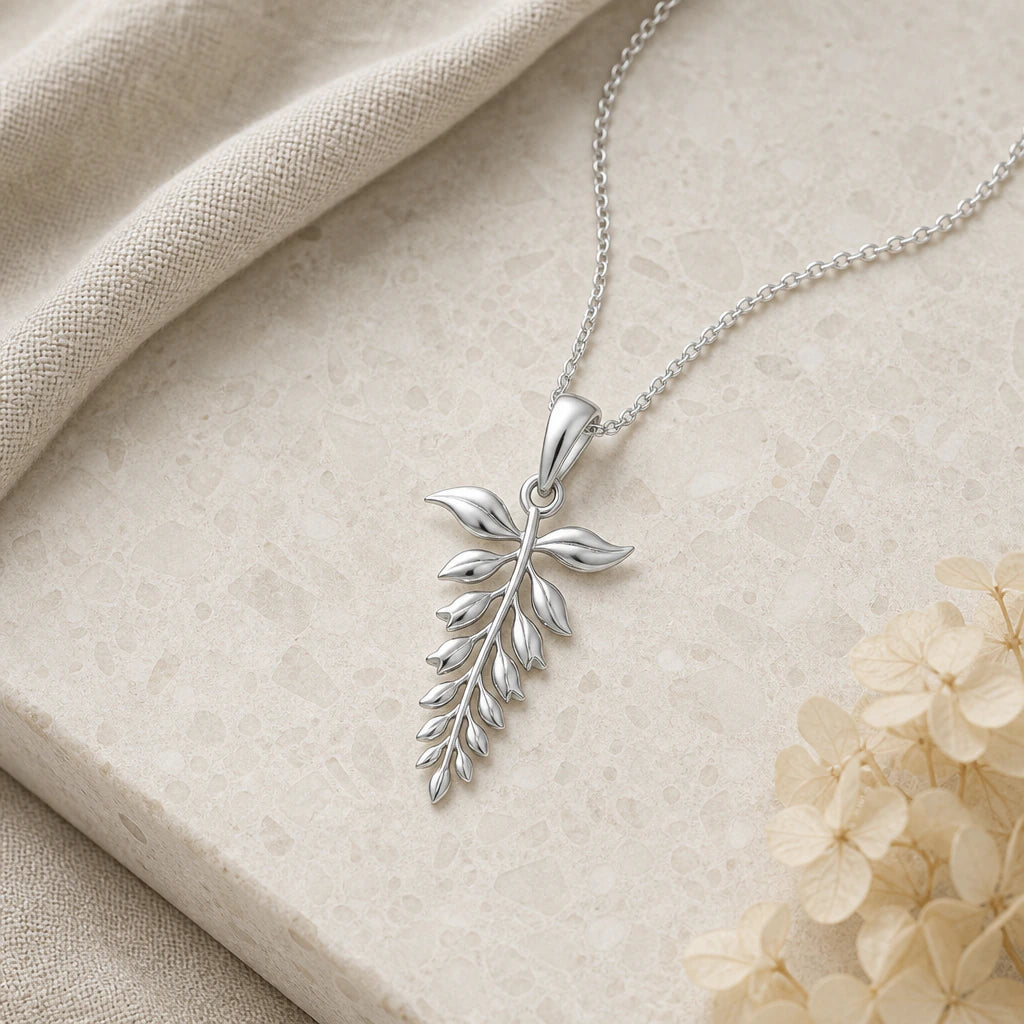 Close-up of silver wisteria flower pendant showing the sculpted detail